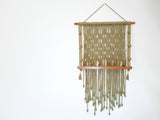 Emplty moss green macrame shelf