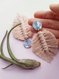 Blush pink macrame feather earring on hand